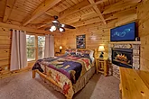 Master bedroom with fireplace in 3 bedroom cabin