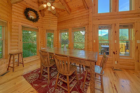 Cabin dining room overlooking a mountain view - Luvin Logs Lodge