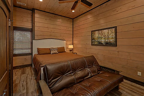 Bedroom with king bed and futon in luxury cabin - Smoky Mountain Memories