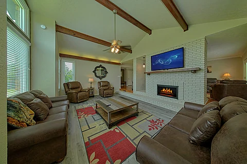 Living room with fireplace in 8 bedroom cabin  - The Oasis
