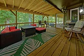 8 bedroom cabin with screened in porch and yard